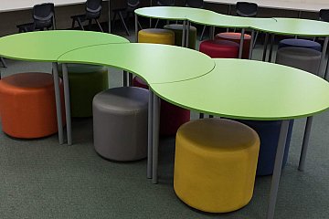 Edward John Eyre High, Custom ottomans with Crescent tables and Ergostack student chairs