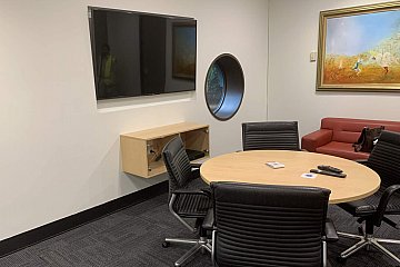 Corporate office custom fitout meeting table and wall mount glass cupboard